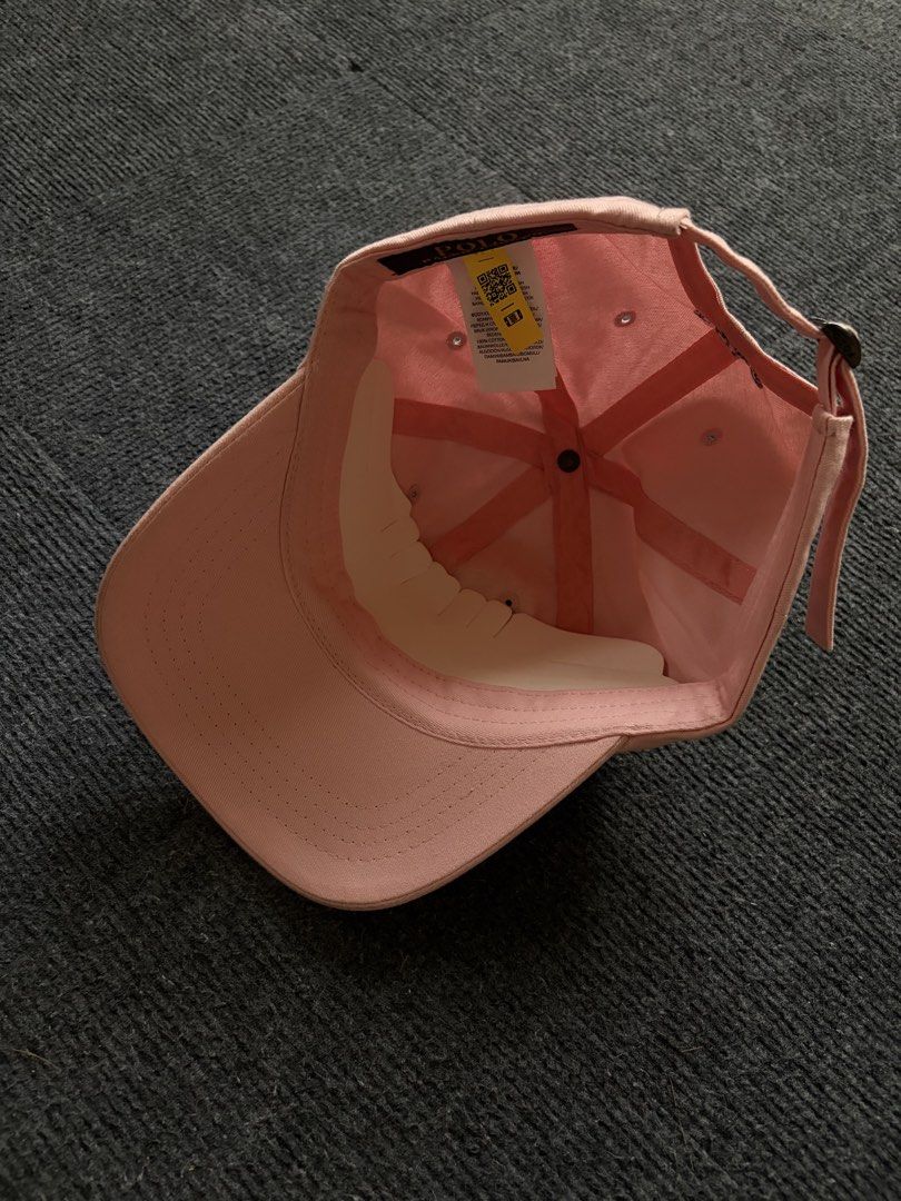 Polo Ralph Lauren Pink Baseball Cap (Category: Caps & Hats) located in Manila. Submitted by toys_hats005 (Listing ID 1467957593, Image 3). Description: - Brand: Polo Ralph Lauren - Color: Pink with dark blue embroidered pony logo - Material: 100% cotton - Fit: Adjustable strap at the back with metal buckle - Details: 'POLO' lettering embroidered above the back strap - Condition: Pristine, clean fabric, with original internal tags and structure in
