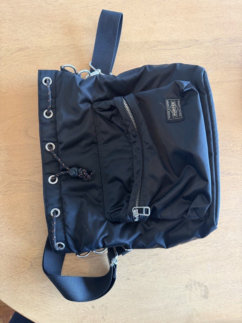 Porter Tokyo Japan Black Nylon Drawstring Shoulder Bag (Category: Sling Bags) located in Cebu City. Submitted by miguelgsarmiento (Listing ID 1467991270, Image 3). Description: - Authentic Porter Tokyo Japan shoulder bag in durable black nylon - Secure drawstring closure with an orange-flecked cord and toggle - Front zipped pocket featuring the classic Yoshida & Company woven label - Detachable black shoulder strap with sturdy silver-toned hardwa