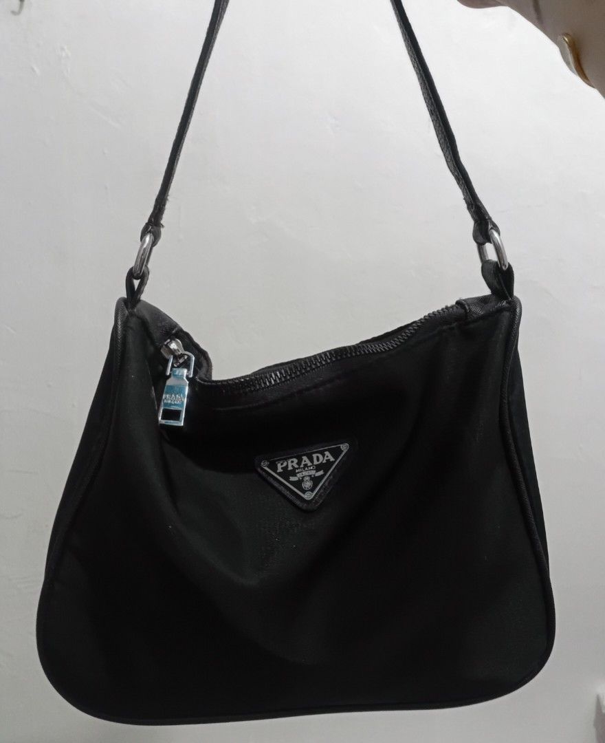Pr ada Black Nylon Kili Bag (Category: Luxury Bags & Wallets) located in Navotas City. Submitted by riyuwi (Listing ID 1467879271, Image 3). Description: PREOWNED LikeNew Lightly Used PR ADA black Nylon kili bag XS -Small black triangle logo & Silvertoned Puller handle zip Nylon body (outer )wth Innerlining Leather Shoulder Strap Missing white tag. (NGA) Min Sign of Used Good Condition 9/10 Model on Posted Picture is for Reference of Sizing of th