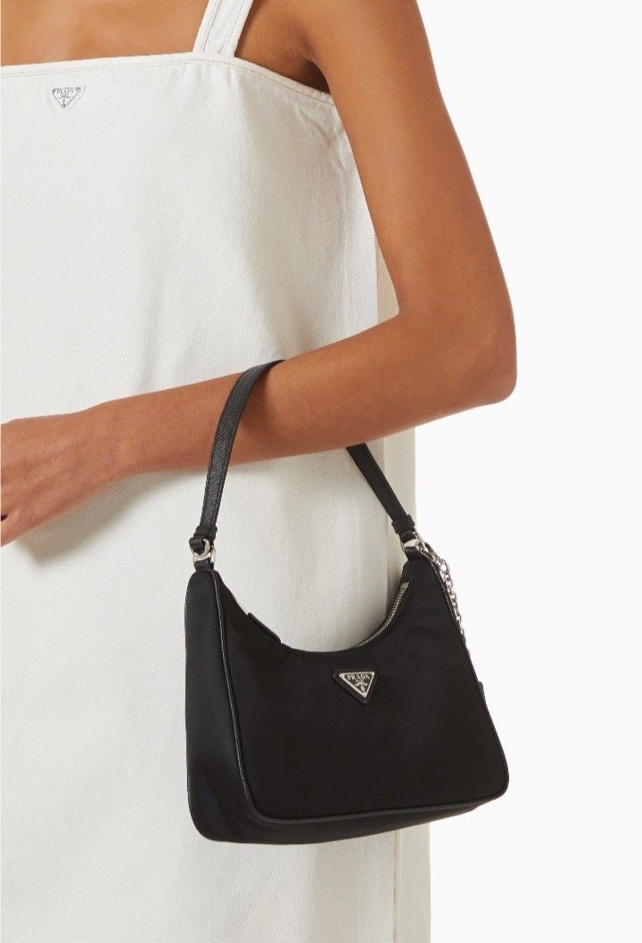 Pr ada Nylon Shoulder Bag (Category: Luxury Bags & Wallets) located in Manila. Submitted by eriiicaspage (Listing ID 1467863444, Image 2). Description: PreOwned Lightly Used Pr.ada nylon shoulder bag in classic black - Silver-tone hardware with iconic front triangle logo plaque -Small - Structured leather handle for comfortable carry - Secure zip-top closure - Signature patterned fabric lining with interior metal logo tag - Clean shape with minim