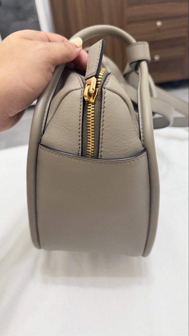 Prada Grey Leather Shoulder Bag (Category: Luxury Bags & Wallets) located in Makati City. Submitted by angie03191 (Listing ID 1467982008, Image 2). Description: - Brand: Prada - Color: Elegant Grey with gold-tone hardware - Material: Genuine leather - Carry options: Double top handles and a detachable shoulder strap - Closure: Top zip closure with branded metal pull - Interior: Clean beige Prada logo jacquard lining with multiple compartments and