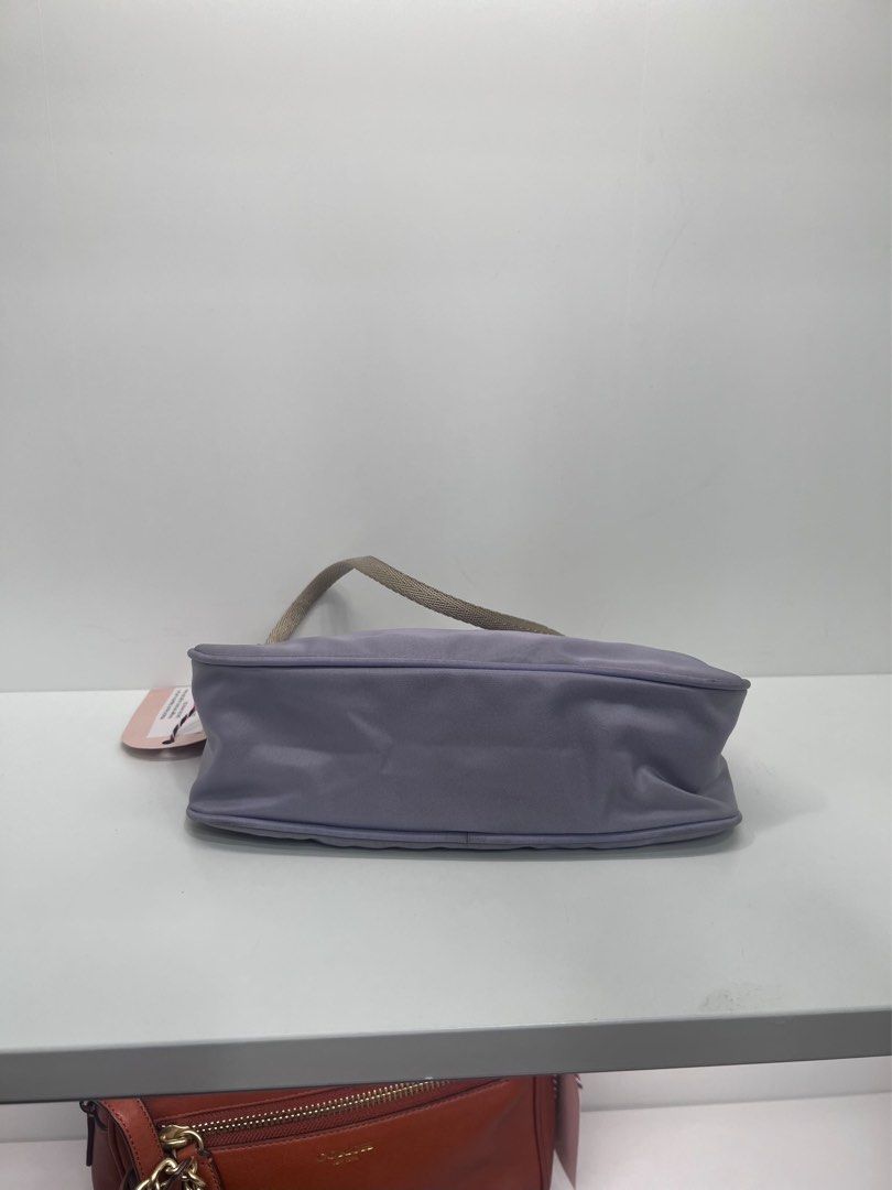 Prada Lilac Nylon Mini Shoulder Bag Bag (Category: Luxury Bags & Wallets) located in Davao. Submitted by boodle4lyf (Listing ID 1467923251, Image 2). Description: Authentic Prada nylon shoulder bag. Zip top closure opening to a matching fabric lining with interior plaque label. In very good condition with minimal signs of use only. .