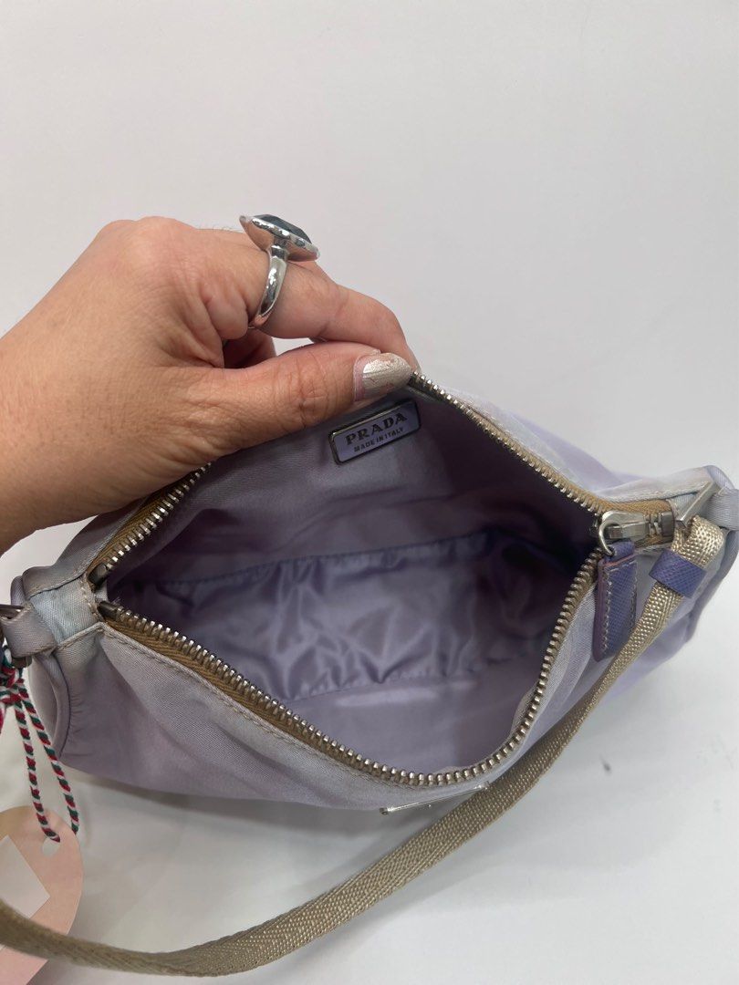 Prada Lilac Nylon Mini Shoulder Bag Bag (Category: Luxury Bags & Wallets) located in Davao. Submitted by boodle4lyf (Listing ID 1467923251, Image 3). Description: Authentic Prada nylon shoulder bag. Zip top closure opening to a matching fabric lining with interior plaque label. In very good condition with minimal signs of use only. .