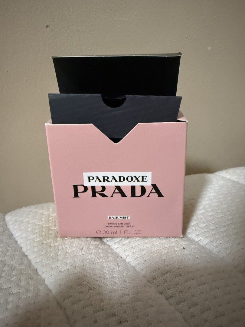 Prada Paradoxe Hair Mist 30ml (Category: Hair) located in Quezon City. Submitted by keyavien (Listing ID 1467972566, Image 1). Description: Kunin niyo na to hahahaha - Item: Prada Paradoxe Hair Mist - Size: 30ml in frosted triangle bottle with black and gold cap - Condition: Like new, sprayed few times ti test - Scent: Floral - Packaging: Includes original pink box (has minor handling marks from storage) .