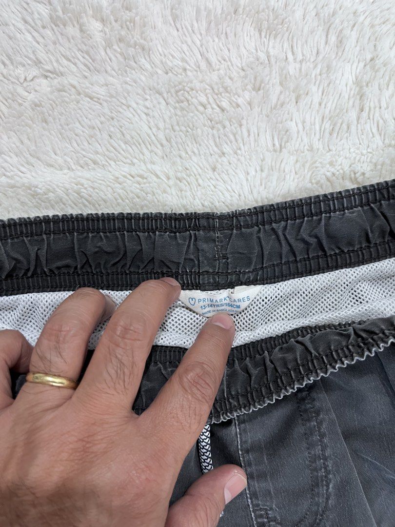 Primark Cares Dark Grey Drawstring Shorts Size 13-14 Yrs (Category: Babies & Kids Fashion) located in Manila. Submitted by kiks_secret_room (Listing ID 1467920396, Image 2). Description: - Brand: Primark Cares - Color: Dark grey - Size: 13-14 years (164cm) - Waist: ~13 inches across (elastic with patterned drawstring) - Length: ~19 inches - Features: Side pockets, cute Tropical Paradise patch near hem, comfortable white mesh lining - Condition: G