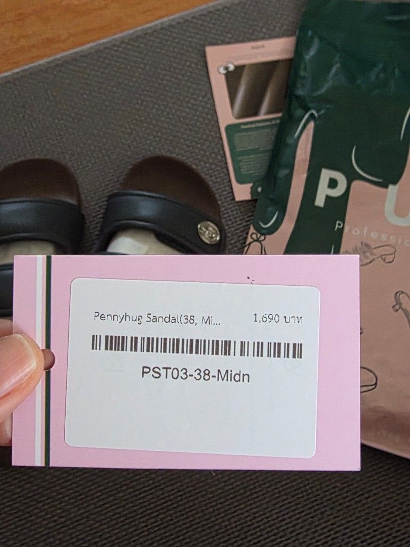 PUFF Pennyhug Sandals Midnight Size 38 (Category: Flats & Sandals) located in Paranaque City. Submitted by icabelulia (Listing ID 1467861139, Image 3). Description: - Brand: PUFF Footwear (Pennyhug) - Color: Midnight - Size: 38 - Design: Two top straps, slingback strap, and stylish silver button accent - Sole: Brown contoured sole with textured anti-slip pattern underneath - Condition: Brand new with original tag attached - Inclusions: Original p