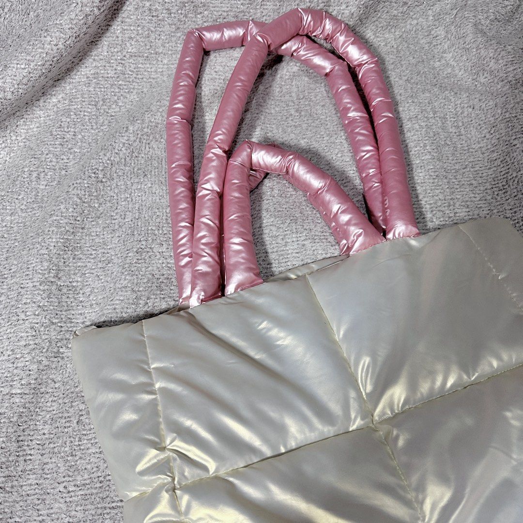 Puffer Tote Bag White with Pink Handles (Category: Tote Bags) located in Paranaque City. Submitted by hershey_august (Listing ID 1467873832, Image 2). Description: - Style: Quilted puffer tote bag - Color: Shiny white with bright pink padded handles - Interior: Black fabric lining with convenient internal pockets - Closure: Secure top zipper - Features: Soft, lightweight design that easily holds daily essentials - Condition: Clean inside and out,