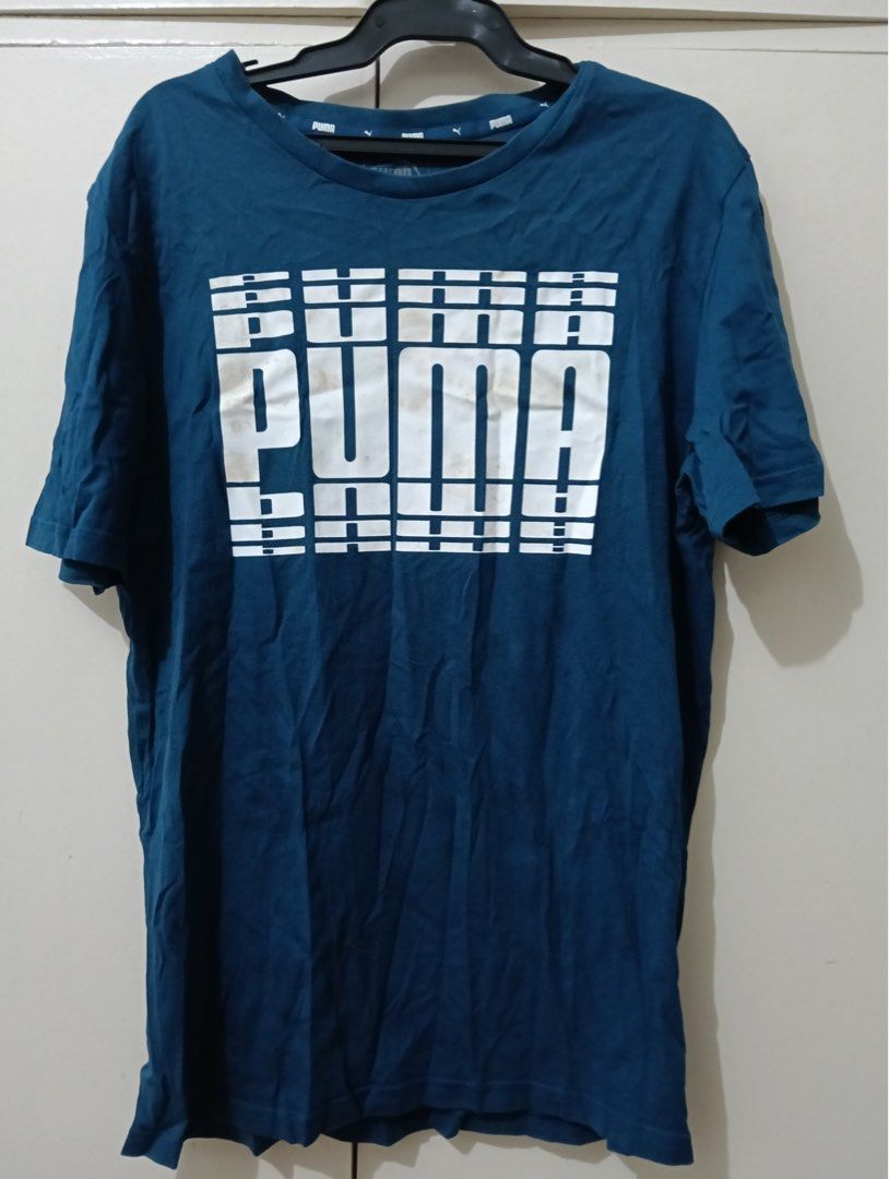 Puma Blue Graphic T-Shirt Size S (Category: Shirts) located in Manila. Submitted by goddesssy (Listing ID 1467839940, Image 1). Description: - Brand: Puma - Color: Teal blue with large white stacked logo - Size: S (US, CAN, EUR) - Material: Comfortable cotton (Made in Bangladesh) - Style: Crew neck, short sleeves - Condition: Great for casual wear or workouts - Fast shipping and reliable seller!.