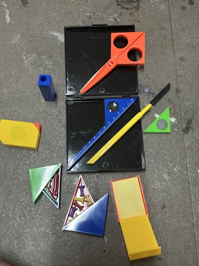 Puzzle stationary (Category: Stationery & School Supplies) located in Bulacan. Submitted by ourdailybreads (Listing ID 1467859441, Image 2). Description: This image shows a vintage Puzzle Stationery Set (often designed in a Mondrian- or Memphis-style geometric layout with primary red, blue, yellow, and green pieces) packed into a compact black plastic case.