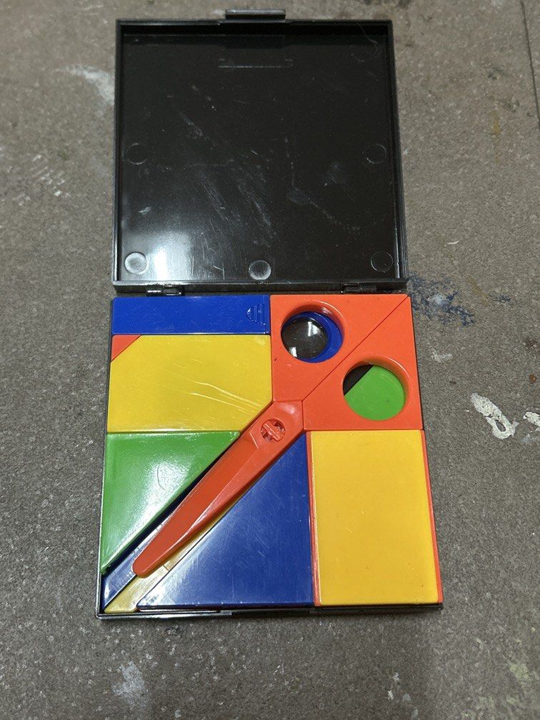 Puzzle stationary (Category: Stationery & School Supplies) located in Bulacan. Submitted by ourdailybreads (Listing ID 1467859441, Image 1). Description: This image shows a vintage Puzzle Stationery Set (often designed in a Mondrian- or Memphis-style geometric layout with primary red, blue, yellow, and green pieces) packed into a compact black plastic case.