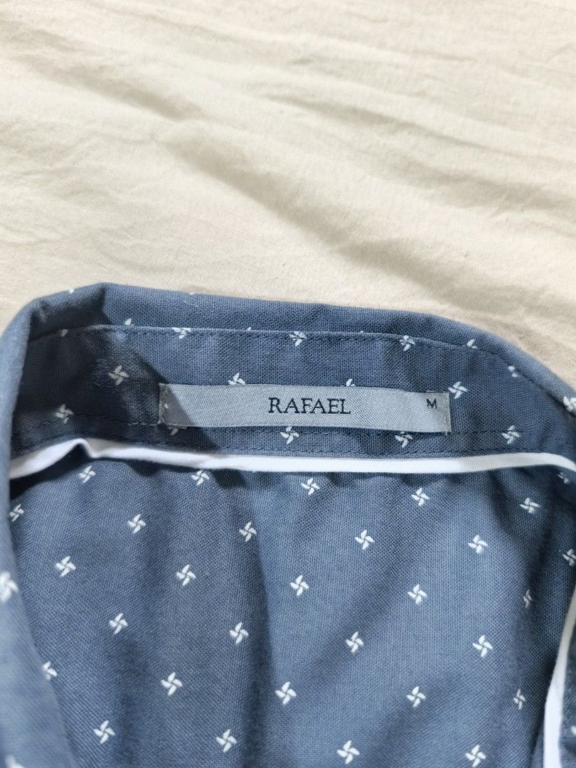 RAFAEL polo shirt (Category: Babies & Kids Fashion) located in Tacloban City. Submitted by curatedbygenz (Listing ID 1467930195, Image 3). Description: Brand: Rafael Size: Medium (M), 10-12 years old Color: Blue with white prints Chest width: Approximately 19 inches.