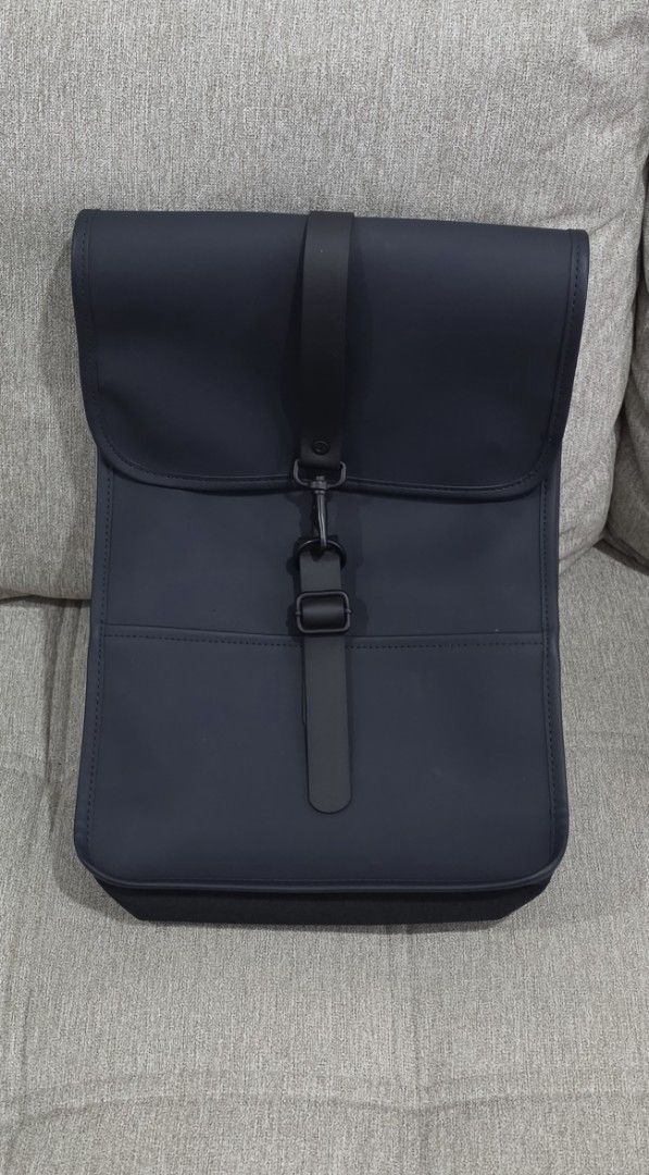 Rains Backpack (Category: Backpacks) located in Quezon City. Submitted by jjamestan (Listing ID 1467889100, Image 1). Description: Selling my RAINS backpack in navy blue / dark blue. Features: • Water-resistant material • Minimalist Scandinavian design • Signature front flap with carabiner closure • Adjustable shoulder straps • Spacious main compartment • Interior zip pocket Perfect for everyday use, work, commuting, and travel. Sleek, functional