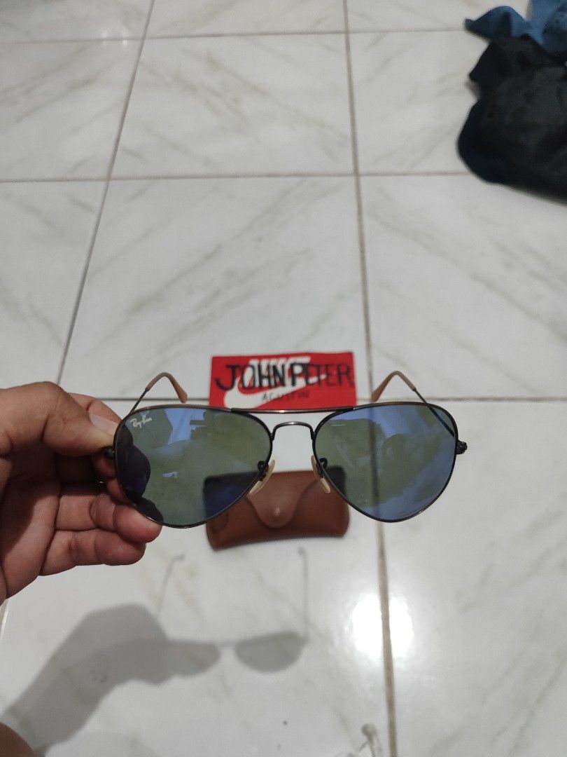 Ray-Ban Aviator Sunglasses Blue Mirror Lenses (Category: Sunglasses & Eyewear) located in Tuguegarao City. Submitted by johnpetera0818 (Listing ID 1468023636, Image 2). Description: - Brand: Ray-Ban - Style: Classic Pilot / Aviator - Lenses: Blue mirror finish with Ray-Ban logo on the right lens and etching on the left lens - Frame: Dark metal - Origin: Made in Italy - Inclusions: Original brown leather case with snap button closure - Condition: 