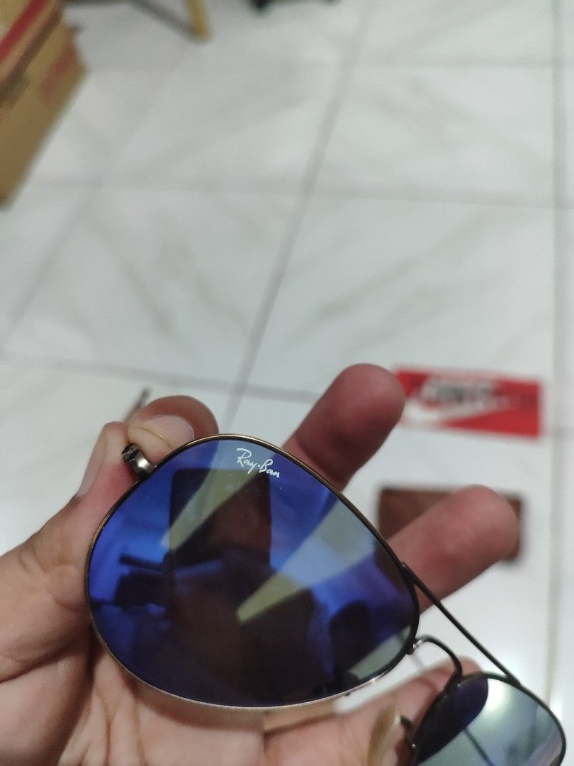 Ray-Ban Aviator Sunglasses Blue Mirror Lenses (Category: Sunglasses & Eyewear) located in Tuguegarao City. Submitted by johnpetera0818 (Listing ID 1468023636, Image 3). Description: - Brand: Ray-Ban - Style: Classic Pilot / Aviator - Lenses: Blue mirror finish with Ray-Ban logo on the right lens and etching on the left lens - Frame: Dark metal - Origin: Made in Italy - Inclusions: Original brown leather case with snap button closure - Condition: 