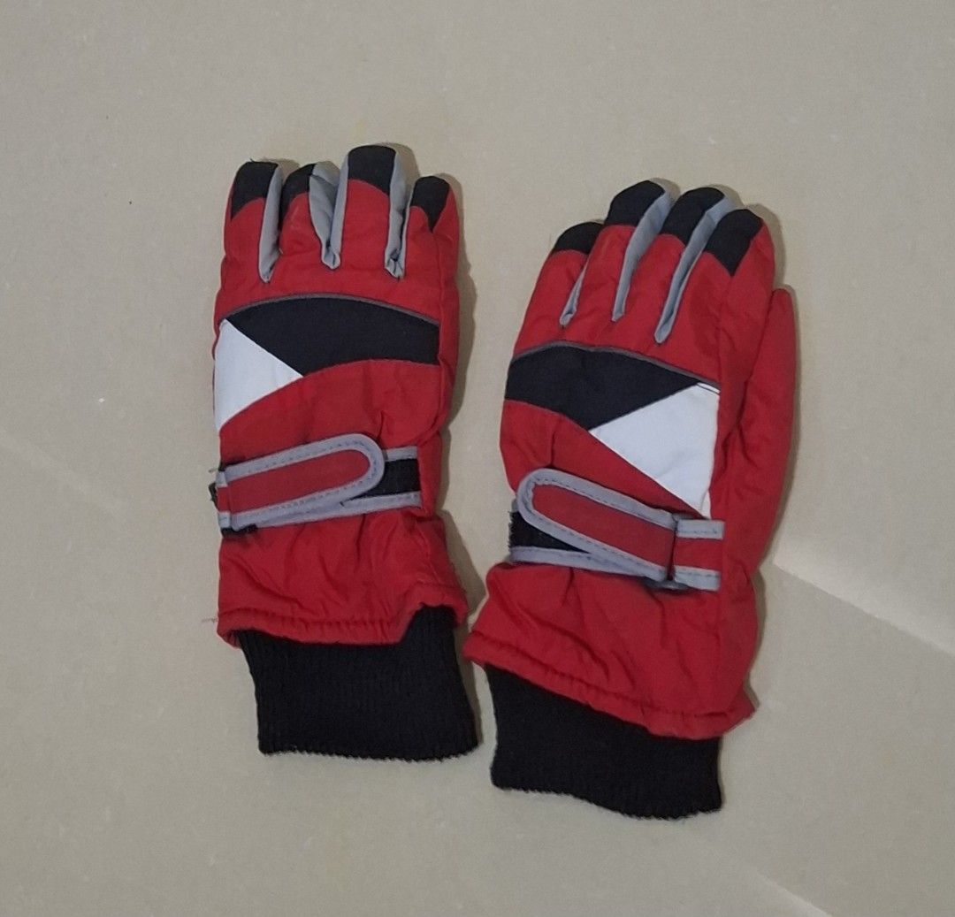 Red and Black Winter Ski Gloves (Category: Babies & Kids Fashion) located in Imus. Submitted by maggieforce (Listing ID 1467931087, Image 2). Description: - Color: Red with black palms, grey finger accents, and a white triangular pattern - Warmth: Thick padding and black knitted cuffs to trap heat - Fit: Adjustable wrist straps for a secure and snug fit - Condition: Brand new and ready for cold weather.
