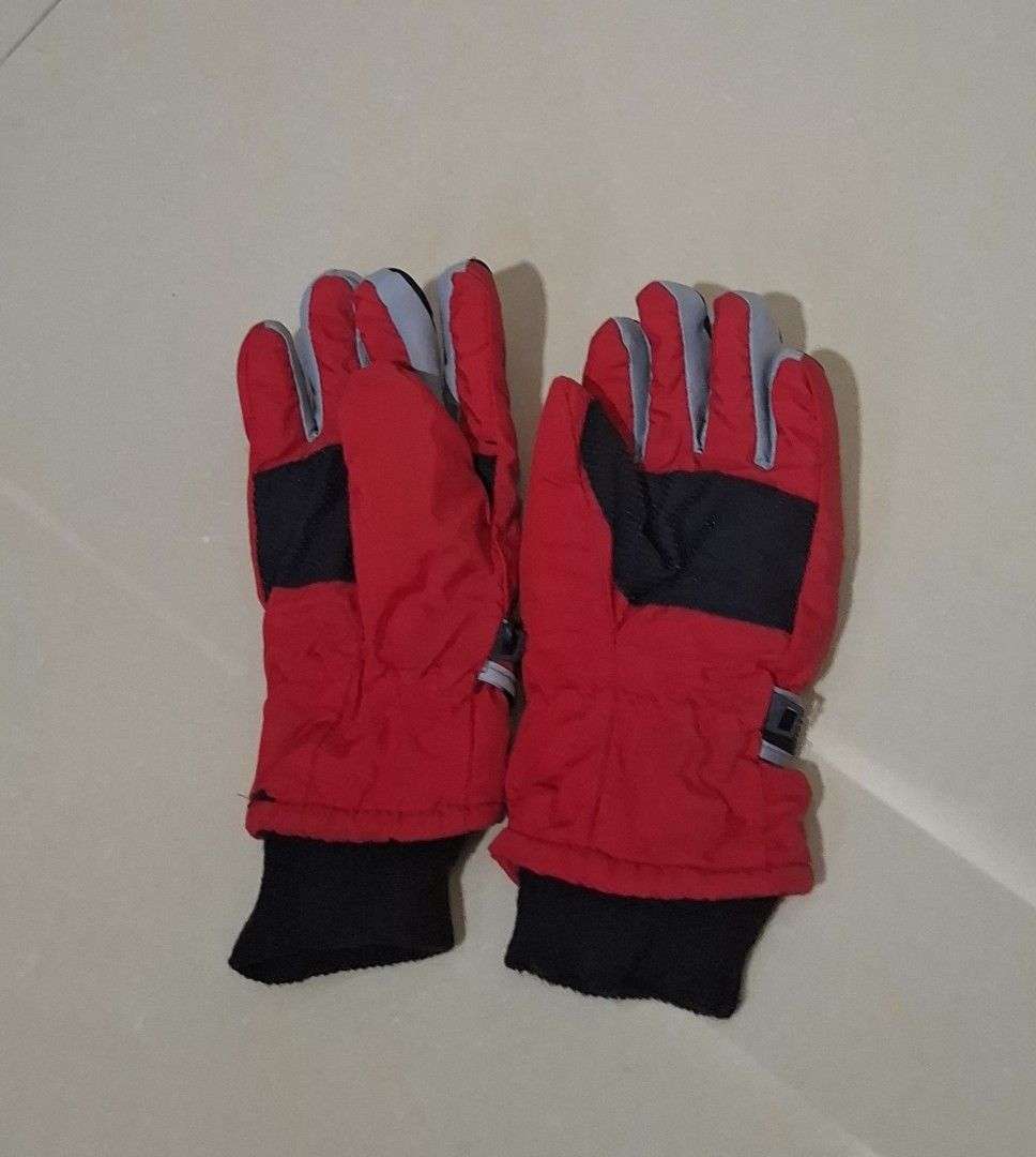 Red and Black Winter Ski Gloves (Category: Babies & Kids Fashion) located in Imus. Submitted by maggieforce (Listing ID 1467931087, Image 1). Description: - Color: Red with black palms, grey finger accents, and a white triangular pattern - Warmth: Thick padding and black knitted cuffs to trap heat - Fit: Adjustable wrist straps for a secure and snug fit - Condition: Brand new and ready for cold weather.