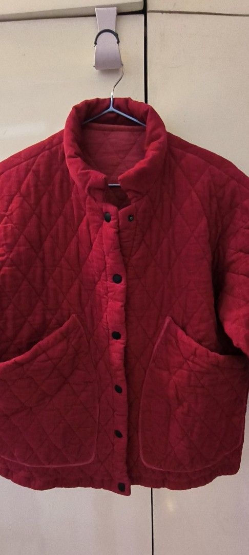 Red Quilted Jacket Puffer Coat with Front Pockets (Category: Coats, Jackets and Outerwear) located in Paranaque City. Submitted by lizpretty05 (Listing ID 1467842419, Image 2). Description: Bright red quilted jacket with diamond stitching pattern. High mock neckline and snap button closure down the front. Two large patch pockets on the lower front. Quilted fabric inside and out. Relaxed boxy fit through the body. Inside tag attached near the bott