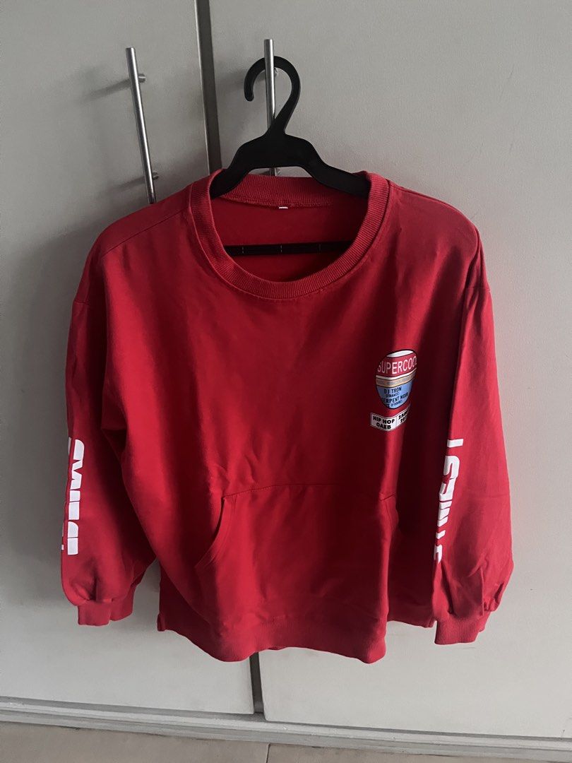 Red Super Cool Graphic Sweatshirt With Front Pocket (Category: Coats, Jackets and Outerwear) located in Manila. Submitted by whosvelvet (Listing ID 1467905661, Image 1). Description: - Color: Red - Design: Eye-catching graphic prints on chest, sleeves, and back - Fit: 22” W, 24.5” L - Features: Front pouch pocket and ribbed cuffs - Material: Comfortable, breathable cotton fabric - SF care of buyer - Payment: Gcash or Maya (NO COD!).