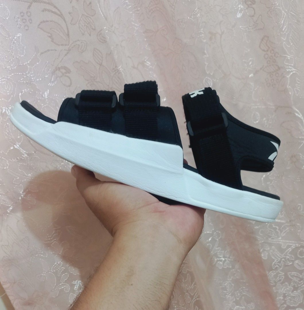 Reebok Black and White Velcro Sandals (Category: Flats & Sandals) located in Cebu City. Submitted by MrLiks_123 (Listing ID 1467968412, Image 3). Description: - Brand: Reebok - Color: Classic Black & White - Style: Chunky sole, open-toe, sporty and casual - Fit: Unisex with adjustable velcro straps across forefoot and ankle for a custom fit - Details: Clear Reebok branding on strap and footbed - Condition: Excellent.