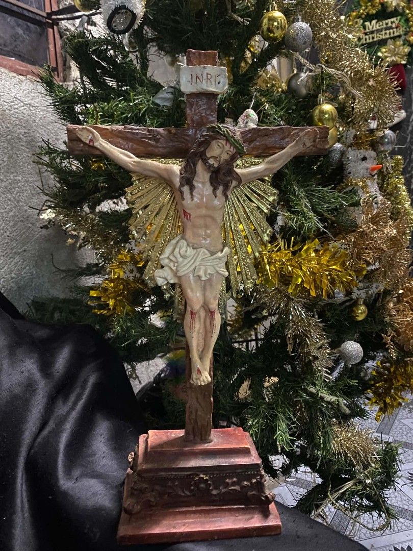 Religious Crucifix Statue Figurine with Stand (Category: Religious Items) located in Caloocan City. Submitted by aragonbene76165 (Listing ID 1468056358, Image 2). Description: - Detailed standing crucifix featuring Jesus and the INRI plaque - Wooden-textured cross design with a decorative golden sunburst accent - Hand-painted figurine crafted from durable resin or composite material - Sturdy, ornate base designed for stable tabletop display - Per