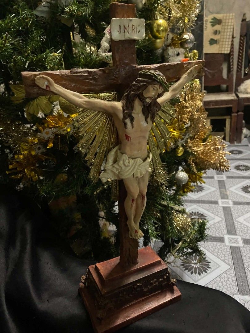 Religious Crucifix Statue Figurine with Stand (Category: Religious Items) located in Caloocan City. Submitted by aragonbene76165 (Listing ID 1468056358, Image 3). Description: - Detailed standing crucifix featuring Jesus and the INRI plaque - Wooden-textured cross design with a decorative golden sunburst accent - Hand-painted figurine crafted from durable resin or composite material - Sturdy, ornate base designed for stable tabletop display - Per