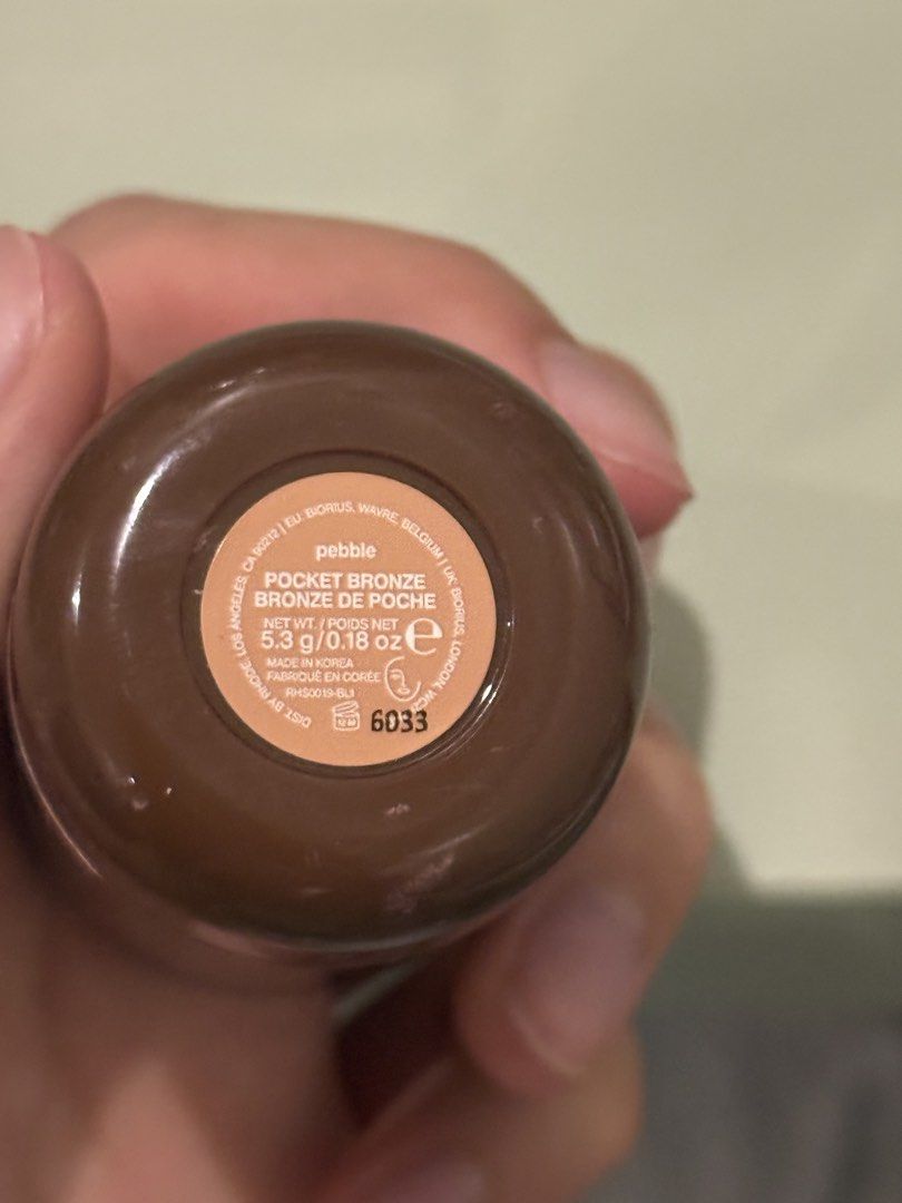 Rhode Pocket Bronze Pebble (Category: Makeup) located in Makati City. Submitted by stallionmegx (Listing ID 1467865424, Image 3). Description: - Item: Rhode Pocket Bronze Cream Bronzer Stick - Shade: Pebble - Size: 5.3g / 0.18 oz - Origin: Made in Korea - Authenticity: 100% authentic Rhode Skin - Condition: Brand new (uncapped only for photo purposes) - Perfect for an easy, dewy, and natural sunkissed look! Authentic.