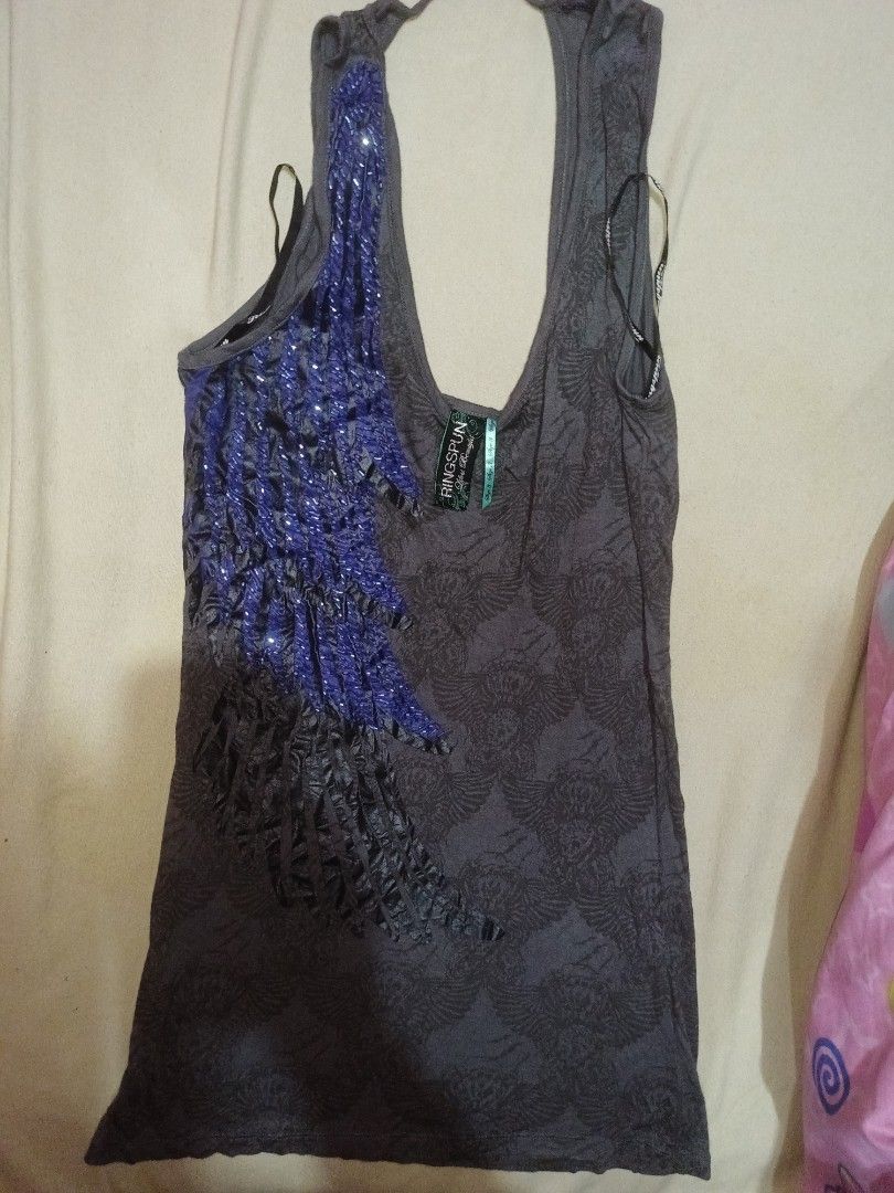 Ringspun Dark Grey Tank Top with Blue Sequin Wing (Category: Sleeveless) located in Iloilo. Submitted by xya.xoxo28 (Listing ID 1467945141, Image 1). Description: - Brand: Ringspun - Color: Dark grey with all-over skull pattern - Feature: Large blue sequin wing design on the front - Cut: Scoop neck with thin straps.