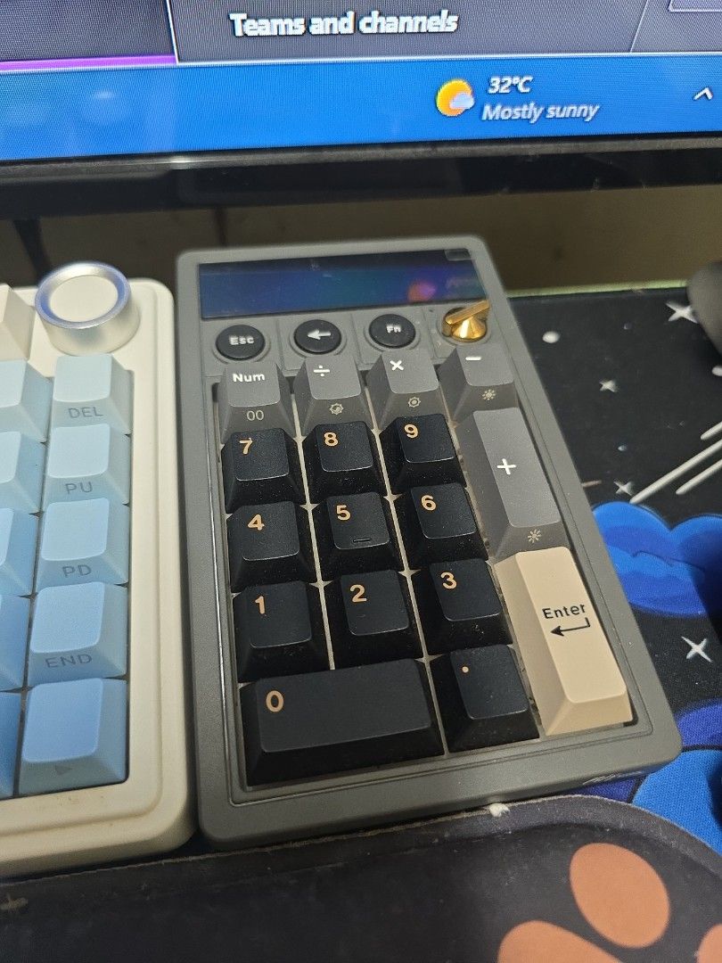 RK Royal Kludge Plantom Numeric Keypad Calculator in Cream Switch (Category: Computer Keyboard) located in Manila. Submitted by engr.ela (Listing ID 1467926085, Image 1). Description: - 2-in-1 Design: Combines a mechanical numeric keypad and a functional calculator with a built-in display screen. - Aesthetic Build: Stylish dark grey chassis, black keycaps, and a premium gold volume knob with clear RGB backlighting. - Tri-Mode Connectivity: Connec