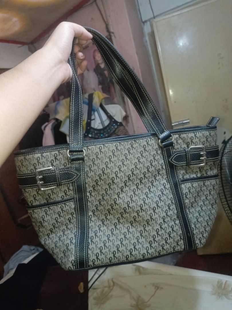 Roberta di Camerino Tote Bag Monogram Print (Category: Luxury Bags & Wallets) located in Pililla. Submitted by stephenivan (Listing ID 1468056047, Image 1). Description: Roberta di Camerino tote bag in a grey and black monogram pattern. Black textured straps and trim with decorative buckle accents on the sides. Top zip closure with black fabric lining inside. Includes internal zippered pockets for organization. Spacious design with sturdy handles