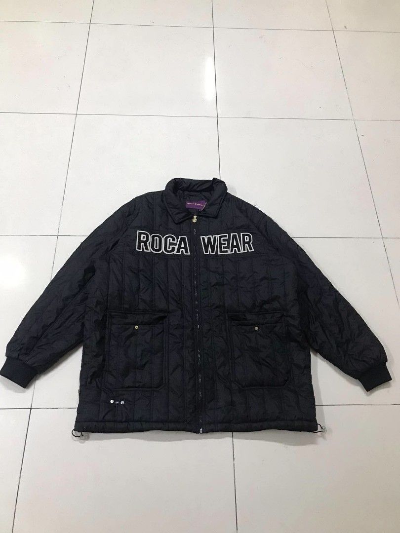 Roca Wear Quilted Black Puffer Jacket 3XL (Category: Coats, Jackets and Outerwear) located in Manila. Submitted by youngstorm-c604 (Listing ID 1467895543, Image 2). Description: - Brand: Roca Wear - Style: Black quilted puffer jacket with relaxed oversized fit - Details: Bold white lettering across the chest - Closure: Zip-up front - Pockets: Functional pockets with snap buttons - Fit: Adjustable drawcord hem for a custom fit - Interior: Purple n