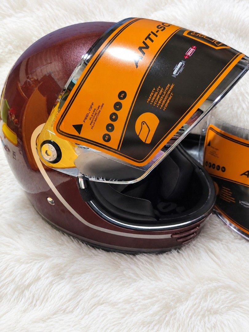 Rook Carter Motorcycle Helmet with Anti-Scratch Visor (Category: Bicycles) located in Mandaluyong City. Submitted by bisou_ph2 (Listing ID 1467931596, Image 2). Description: - Brand: Rook - Color: Brown metallic finish with chic chrome trim - Condition: Brand new, never worn, with original protective labels attached - Visor: Anti-scratch visor with protective film still on - Bonus: Includes an extra replacement visor in the package - Interior: Co