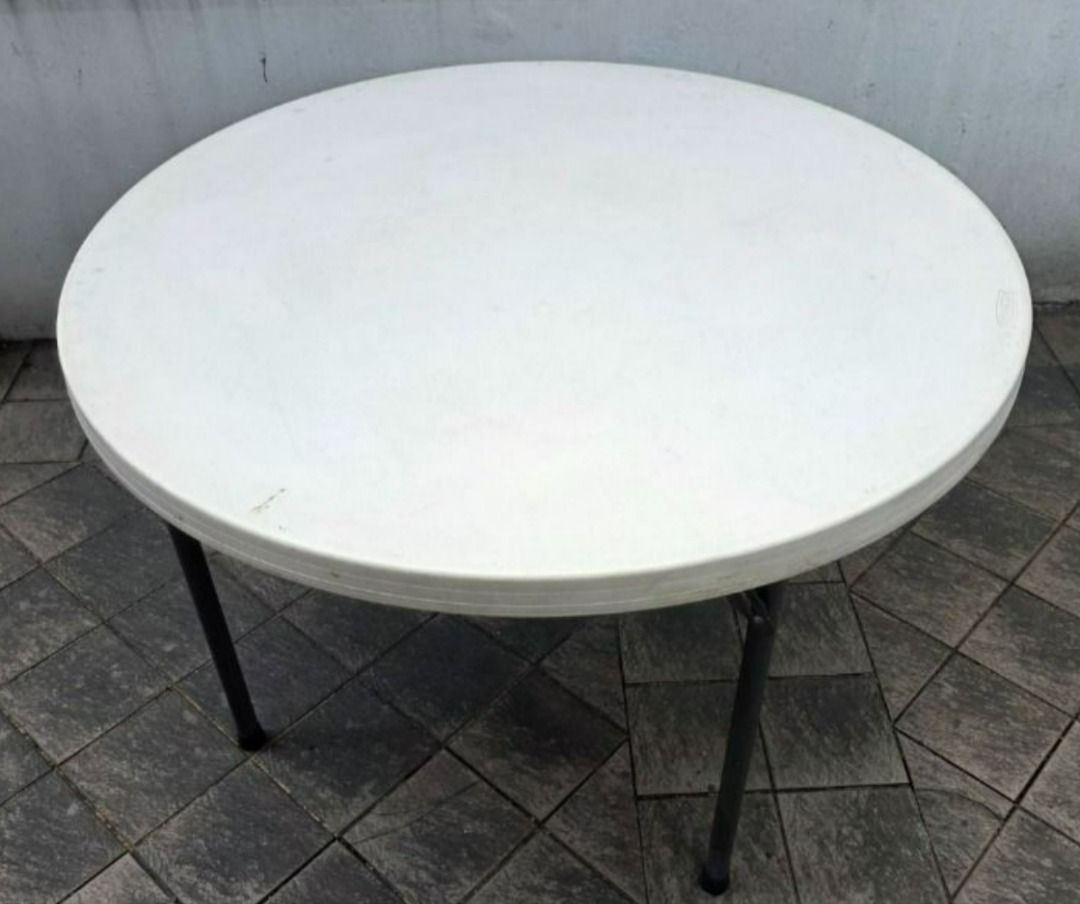 Round plastic folding table with metal legs (Category: Tables & Sets) located in Quezon City. Submitted by willy.willy6 (Listing ID 1468007011, Image 1). Description: - Durable white plastic top with a clean, ready-to-use surface - Sturdy black metal folding legs for stability - Standard size that comfortably seats 4 people - Versatile extra surface for parties, dining, or craft projects - Folds completely flat for convenient storage in a closet 