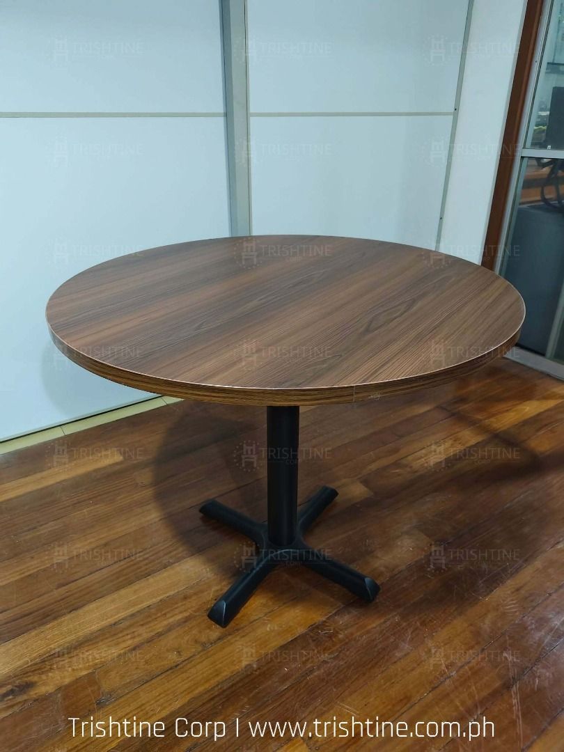 Round Wooden Conference Table with Black X-Base (Category: Tables & Sets) located in Caloocan City. Submitted by jim.trishtineofficefurnitures (Listing ID 1467892808, Image 1). Description: - Round wooden top with a rich grain finish - Sturdy black metal X-base for solid support - Clean edges and smooth surface - Ideal for small dining spaces, office breakrooms, or casual meeting rooms - Durable build, ready for daily use DISCLAIMER: PRICE IS FOR