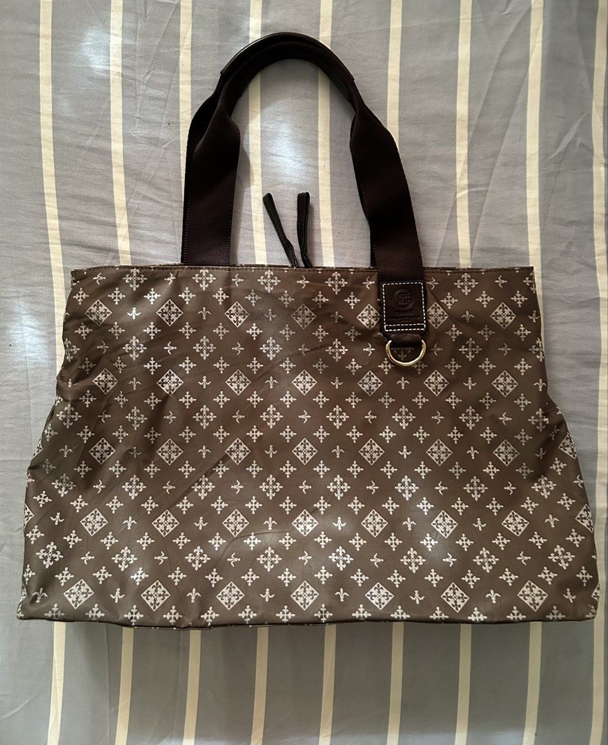 Russet Monogram Brown Tote Bag (Category: Tote Bags) located in Bambang. Submitted by mythriftstyle (Listing ID 1467905022, Image 1). Description: - Brown tote bag with all-over russet monogram print - Double shoulder straps for comfortable carrying - Top zip closure with magnetic snap buttons on the sides - Brown fabric-lined interior featuring a zippered pocket - Interior embossed leather brand logo patch - Elegant gold-toned hardware throughou