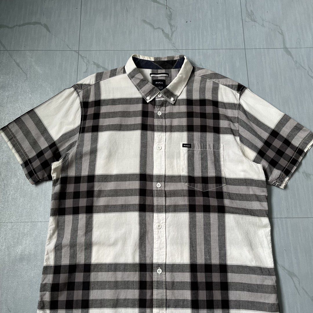 Rvca Plaid Short Sleeve Button Down Polo Shirt (Authentic) (Category: Tshirts & Polo Shirts ) located in Cavite. Submitted by newclassicwear (Listing ID 1467926529, Image 2). Description: Size XL On Tag (23width 29length) Excellent Condition None Any Issue 9.8 Honest Color Rate Can Do Meet Up Around Sm Tanza Cavite Tanza📍 RVCA plaid button-down shirt in black, white, and grey. Size XL regular fit with short sleeves and a chest pocket. Great soli