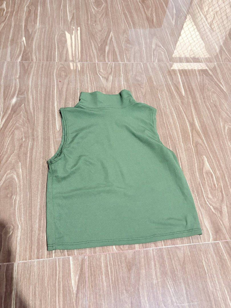 Sage Green Mock Neck Ribbed Crop Top (Category: Sleeveless) located in Manila. Submitted by thriftwithgem (Listing ID 1467898343, Image 1). Description: - Color: Sage green - Style: Sleeveless ribbed crop top with mock neckline - Fit: Cropped length, great stretch, pairs well with high-waisted jeans or skirts - Condition: Clean, no stains or holes - Perfect basic piece for everyday wear.