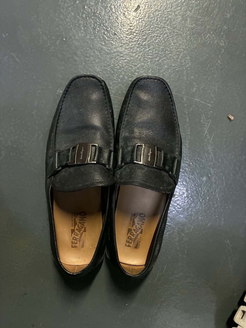 Salvatore Ferragamo Black Leather Loafers (Category: Dress Shoes) located in Manila. Submitted by kissa.1890 (Listing ID 1468040180, Image 1). Description: - Brand: Salvatore Ferragamo - Material: Genuine black leather with textured grain finish - Hardware: Silver-tone buckle across the top - Insole: Tan leather with stamped brand logo - Design: Easy slip-on style for daily wear - Versatility: Classic menswear, pairs well with slacks or denim.