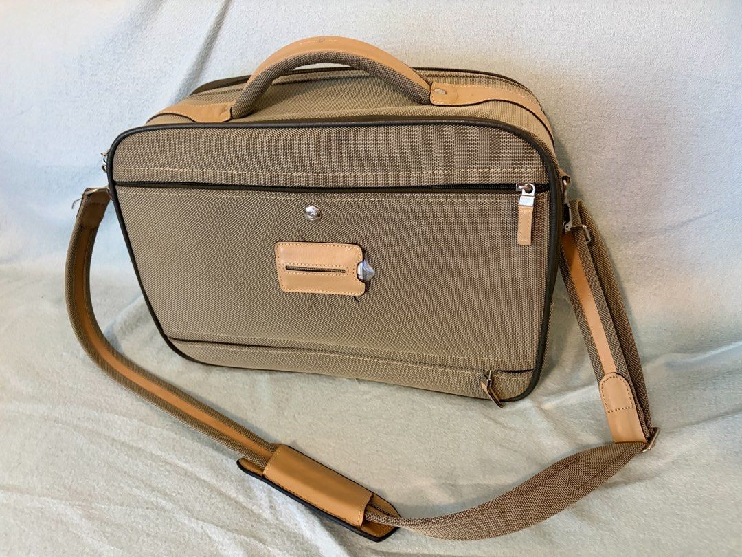 Samsonite business/travel bag (Category: Briefcases) located in Taguig. Submitted by domie (Listing ID 1467890325, Image 3). Description: - Brand: Samsonite - Color: Gray fabric with beige leather trim - Carry options: Sturdy top handle and adjustable shoulder strap with comfort pad - Organization: Multiple zip compartments and spacious main interior with patterned lining - Hardware: Silver metal zippers and clasps - Condition: Light wear on leat