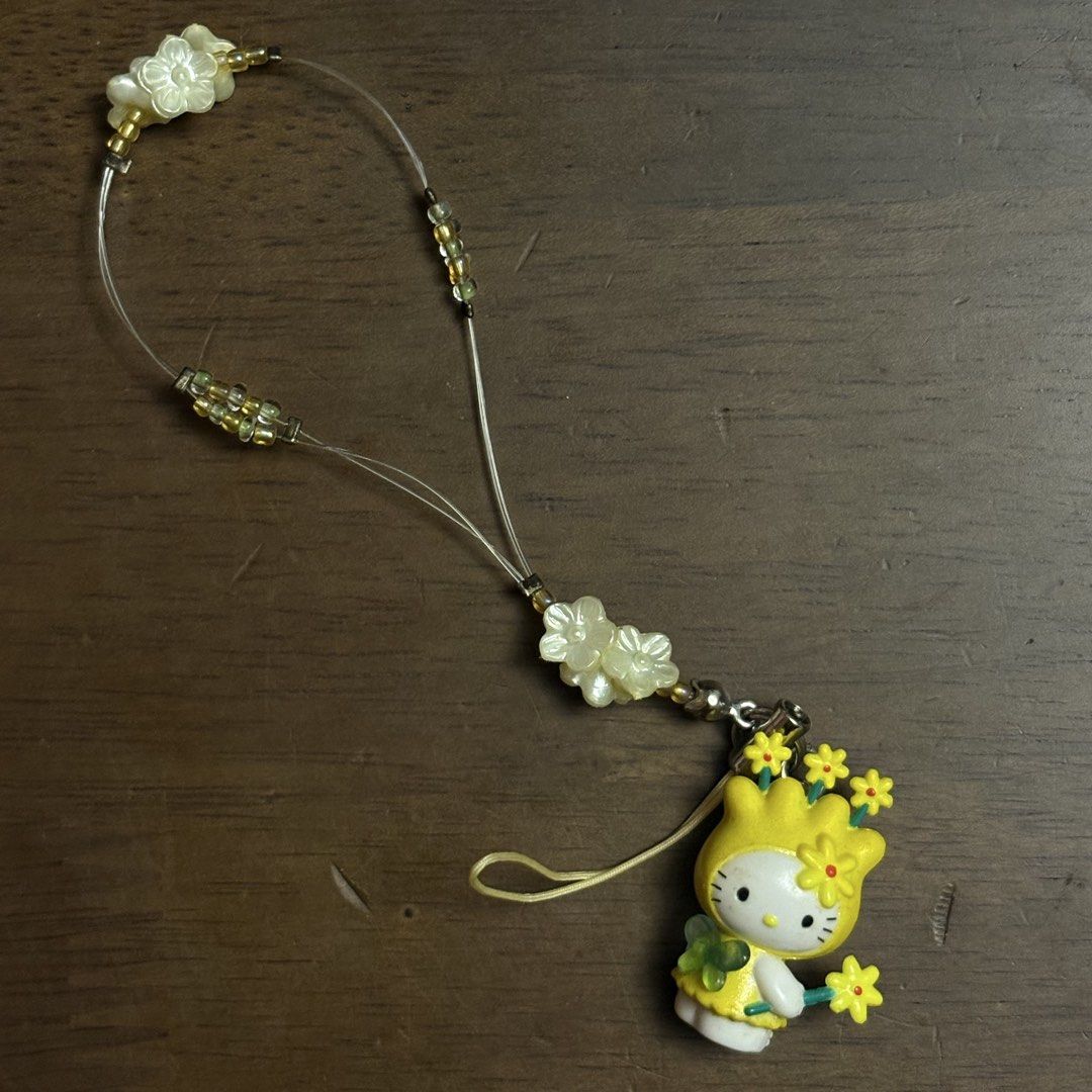 Sanrio 2000 Hello Kitty Yellow Flower Phone Strap Charm (Category: Character Goods) located in Manila. Submitted by aobacafe (Listing ID 1467955295, Image 2). Description: - Authentic Sanrio official merchandise made in Japan (Year 2000 vintage) - Features Kitty dressed in an adorable yellow flower outfit holding a flower wand - Comes with the original colorful beaded strap - Includes the original packaging backing card for true collectors - Rare