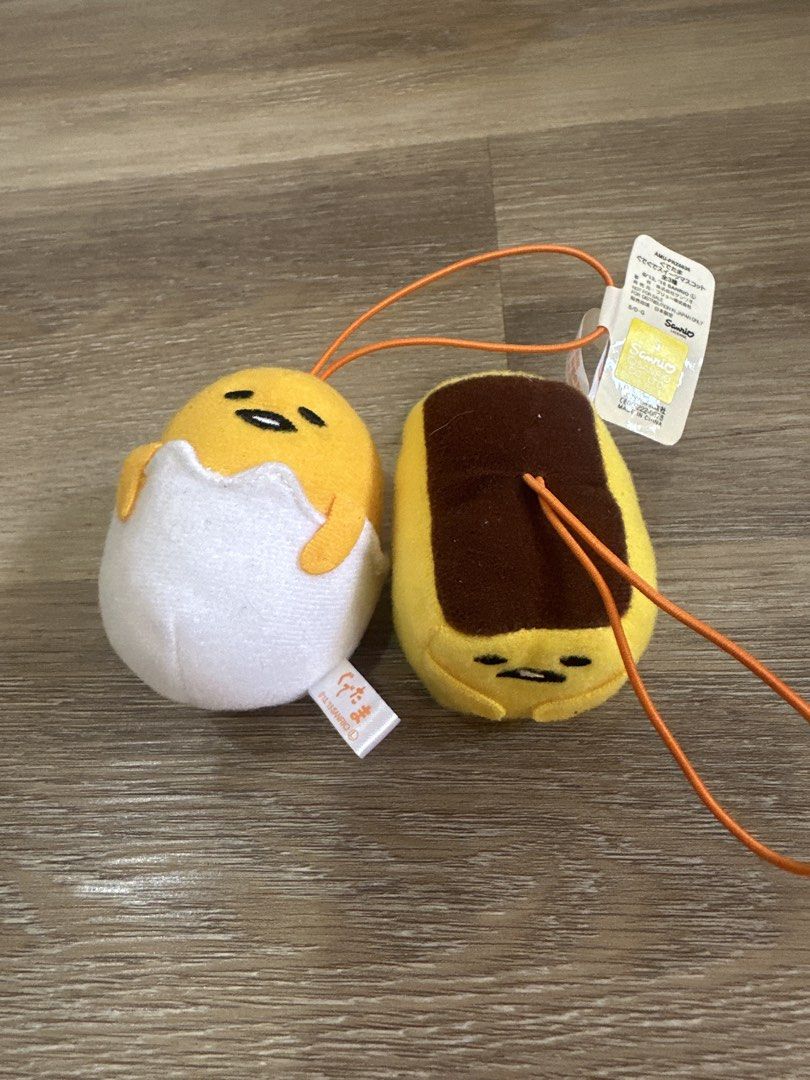 Sanrio Gudetama Plush Mascot Straps Set (Category: Plushies & Soft Toys) located in Cainta. Submitted by shopbyyna (Listing ID 1467892792, Image 1). Description: - Authentic Sanrio Gudetama plush mascots (Set of 2: Egg Shell & Toast) - Comes with original Sanrio fabric tags (Dated 2013 & 2015) - Equipped with orange hanging straps, perfect for bags, keys, or phones - Rare find for Gudetama collectors!.