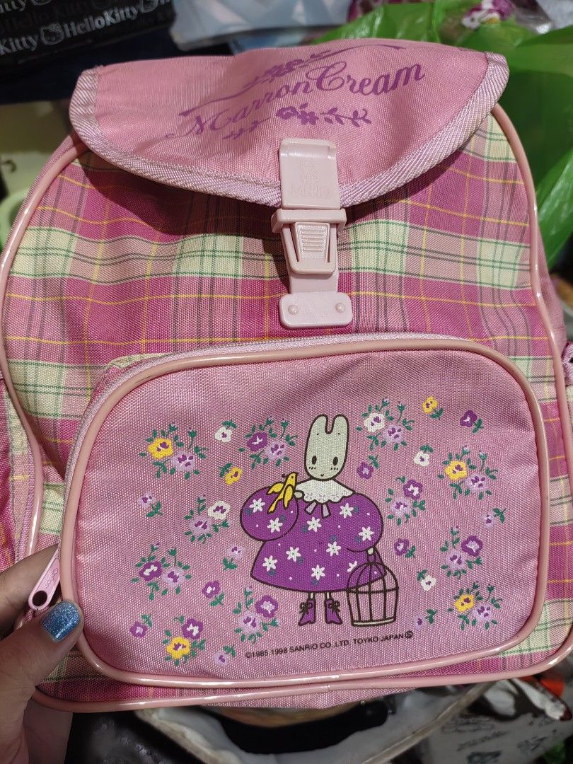 Sanrio Marron Cream Pink Plaid Backpack (Category: Backpacks) located in Manila. Submitted by zaekim1380 (Listing ID 1467910754, Image 3). Description: - Authentic vintage Sanrio Marron Cream backpack from 1985/1998 - Adorable pink plaid design with front pocket character graphics - Secure flap closure with buckle snap - Convenient side pockets and adjustable shoulder straps - Great size for school, daily use, or Sanrio collectors.