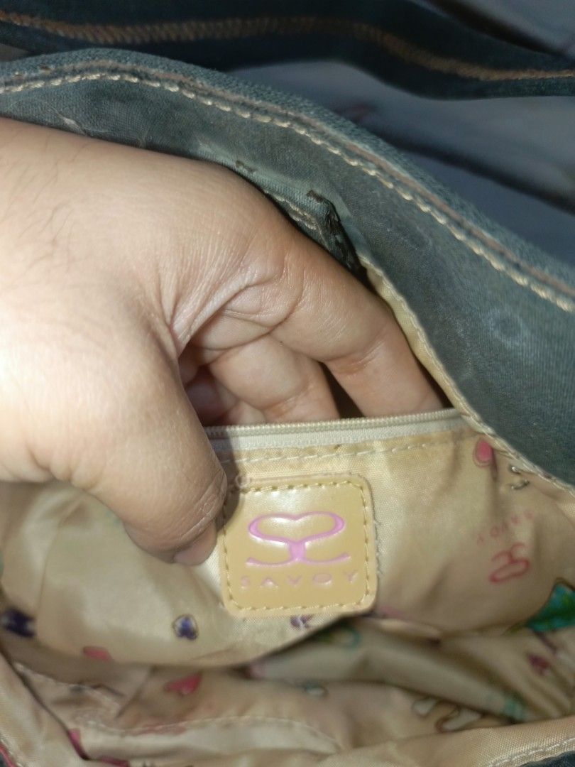 Savoy Y2K shoulder bag (Category: Shoulder Bags) located in Pililla. Submitted by stephenivan (Listing ID 1468056138, Image 3). Description: - Style: Savoy shoulder bag in beige canvas with all-over monogram print - Straps: Dark green straps adorned with sparkly turquoise and pink gems - Interior: Cute heart and shoe print lining with a zippered pocket and brand logo patch - Closure: Secure top magnetic snap - Capacity: Roomy enough to fit all yo