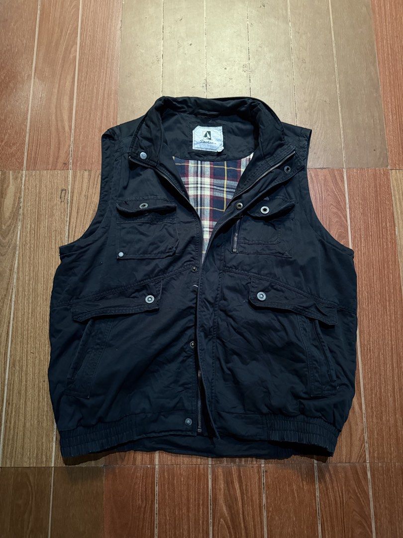 Seevlac Black Utility Vest with Plaid Lining (Category: Vests) located in Dasmarinas. Submitted by kylebecker (Listing ID 1467943947, Image 1). Description: - Brand/Style: Seevlac black utility vest - Lining: Cozy plaid flannel with red, yellow, and blue stripes - Pockets: Multiple functional pockets on the chest and lower front - Closure: Secure zip and snap button front closure - Details: Ribbed hem and stand collar - Fit/Use: Great layering pi