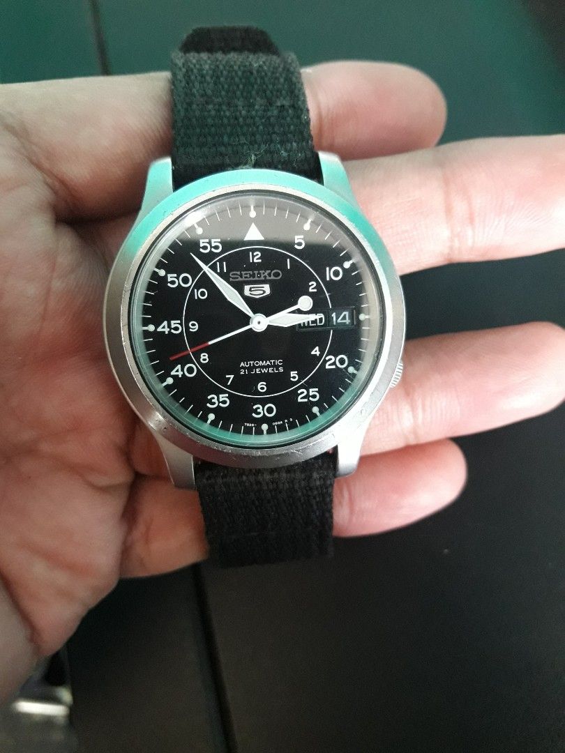 Seiko 5 Automatic Field Watch with Black Canvas Strap (Category: Men's Watches) located in Paranaque City. Submitted by omaraguirre (Listing ID 1467909500, Image 3). Description: - Model: Seiko 5 Automatic Watch - Dial: Classic green military-style with Arabic numerals - Movement: Reliable 21-jewel 7S26 automatic movement with transparent exhibition caseback - Strap: Durable black fabric NATO strap with sturdy metal hardware - Features: Convenien