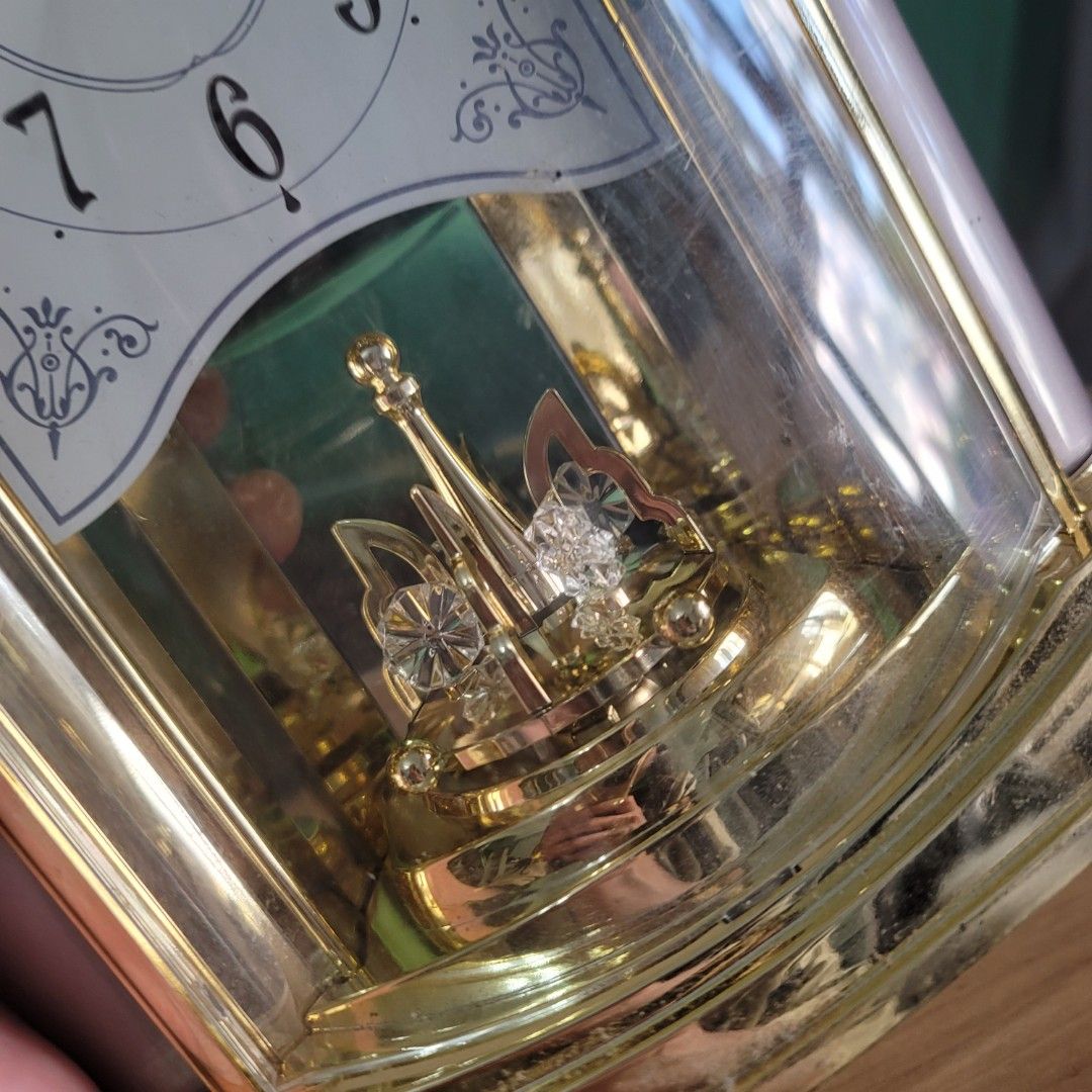 Seiko Gold Tone Mantel Clock With Rotating Pendulum (Category: Clocks) located in Pasig City. Submitted by bunny.bella (Listing ID 1467916087, Image 3). Description: - Brand: Seiko - Design: Pale pink body with elegant gold-tone trim and arched glass front - Dial: Classic white face with black Arabic numerals and ornate corner accents - Special Feature: Beautiful rotating crystal pendulum inside - Power: Battery-operated - Ideal for: Mantle piece