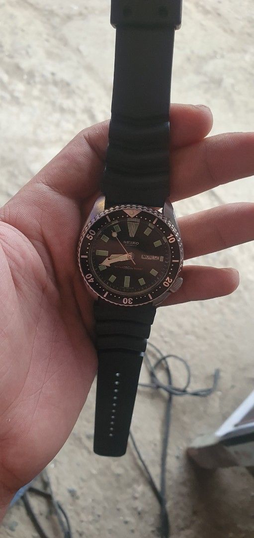 Seiko slim turtle Automatic Diver 150m Watch Black Dial (Category: Men's Watches) located in Zamboanga. Submitted by sarahjaneatari (Listing ID 1467903857, Image 3). Description: - Vintage Seiko automatic diver watch - Black dial with 3 o'clock day-date window - Rotating bezel with clear markings - Ribbed black rubber strap with buckle closure - Stainless steel case back with iconic tsunami wave engraving - Automatic movement (runs on wrist motio