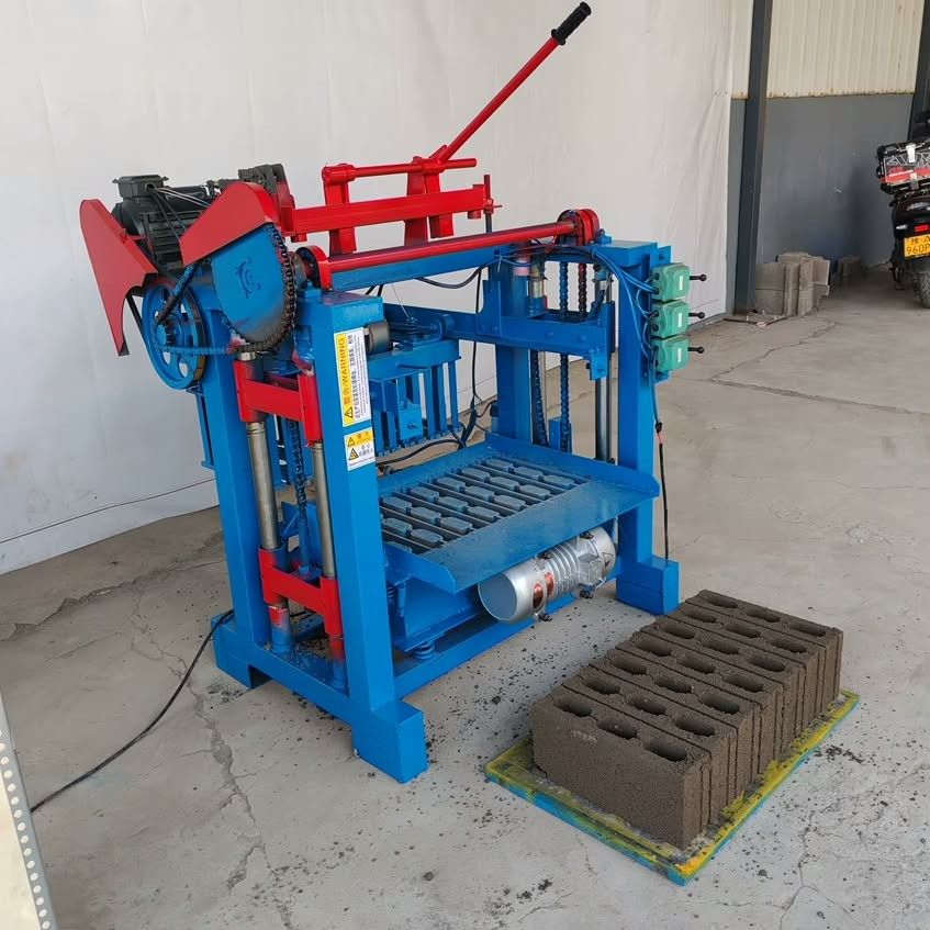 Semi Automatic CHB MACHINE (Category: Industrial Equipment) located in Quezon City. Submitted by brightbear_7ffe85 (Listing ID 1467935578, Image 1). Description: - Heavy-duty blue and red concrete block making machine - Motor-powered with reliable chain drives and manual levers - Sturdy solid steel frame construction with safety warning stickers - Ideal for small-scale construction or brick manufacturing yards - Local pickup only due to heavy wei