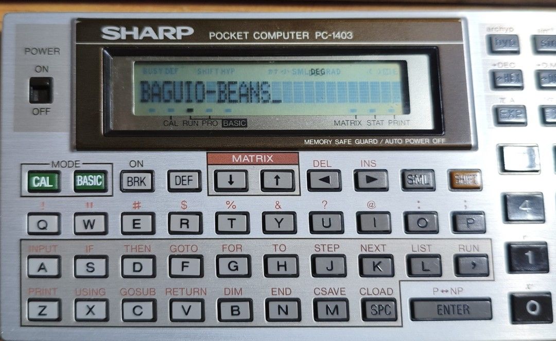 Sharp Pocket Computer PC-1403 with Case (Category: Desktops) located in Baguio. Submitted by baguiobeans (Listing ID 1467862555, Image 1). Description: - Vintage Sharp PC-1403 pocket computer with original hard cover case - Powers on and currently displays text - Full QWERTY keyboard with scientific calculator and matrix operation functions - Includes hard case featuring printed reference guides for matrix operations and error codes inside - Grea