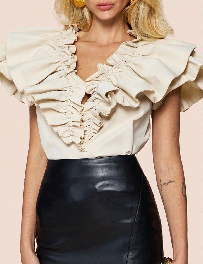 Shein Apricot Ruffled Blouse Top (Category: Blouses) located in Binan City. Submitted by myprelovedhaul (Listing ID 1467927150, Image 1). Description: This item is a SHEIN apricot ruffle-trim plunge V-neck blouse, known for its dramatic cascading ruffles along the neckline and short flutter sleeves. It is typically listed under sub-brands or listings like SHEIN LUNE or SHEIN Clasi..