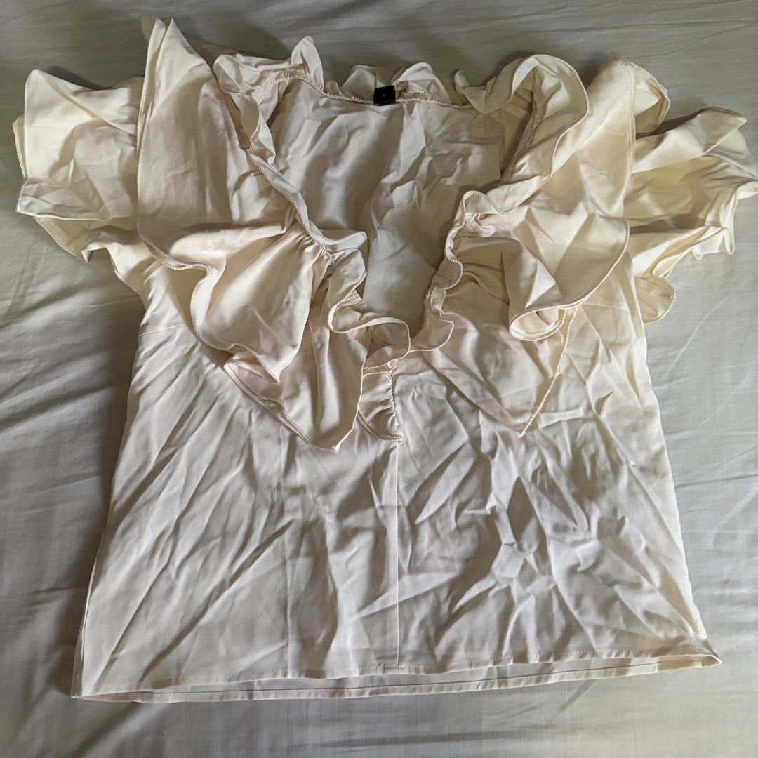 Shein Apricot Ruffled Blouse Top (Category: Blouses) located in Binan City. Submitted by myprelovedhaul (Listing ID 1467927150, Image 2). Description: This item is a SHEIN apricot ruffle-trim plunge V-neck blouse, known for its dramatic cascading ruffles along the neckline and short flutter sleeves. It is typically listed under sub-brands or listings like SHEIN LUNE or SHEIN Clasi..